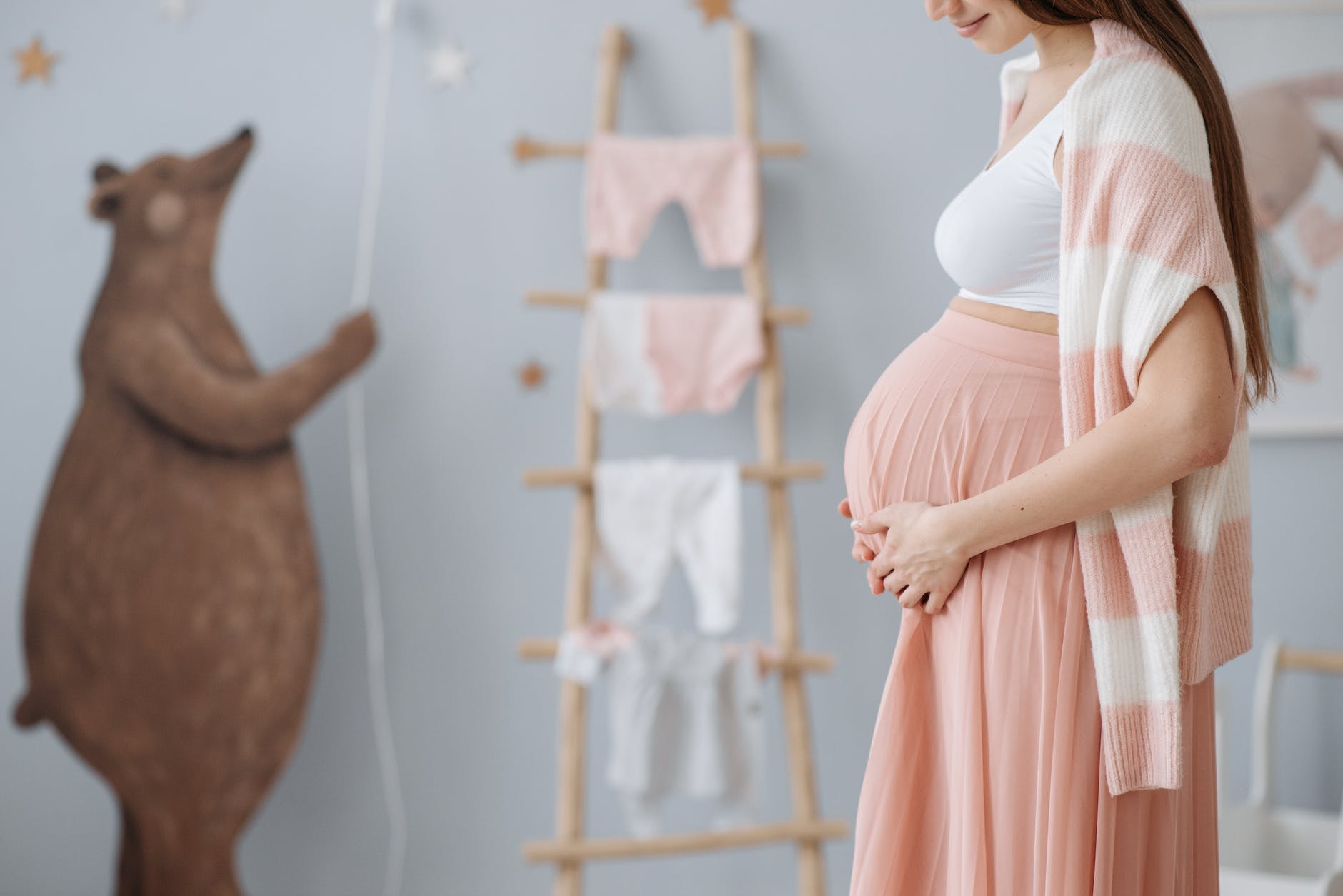an expected mother rubbing holding her baby bump